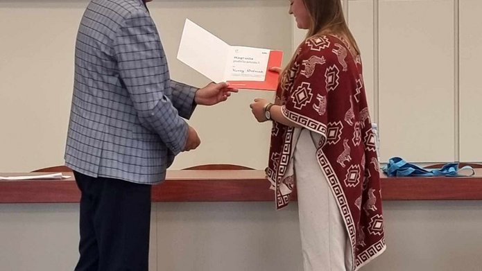 Organizator Konkursu wręcza dyplom i przekazuje gratulacje wygranej w konkursie Karinie Woźniak