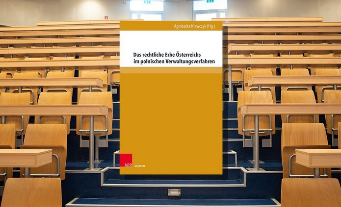 Książka na tle auli akademickiej.