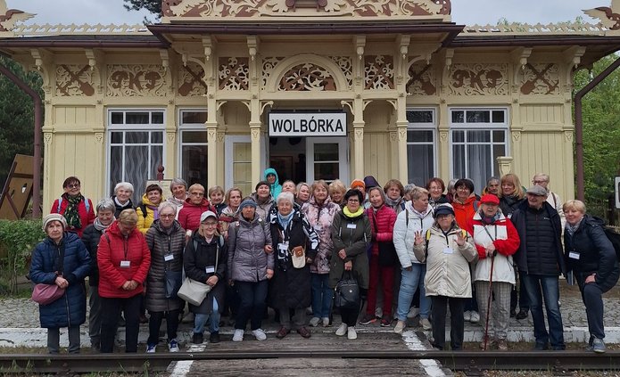 Zdjęcie zbiorowe seniorów podczas wycieczki do Skansenu Rzeki Pilicy