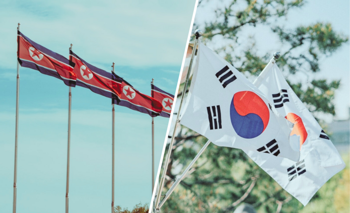 Po lewej stronie cztery flagi Korei Północnej, a po prawej stronie dwie flagi Korei Południowej/Four North Korean flags on the left and two South Korean flags on the right
